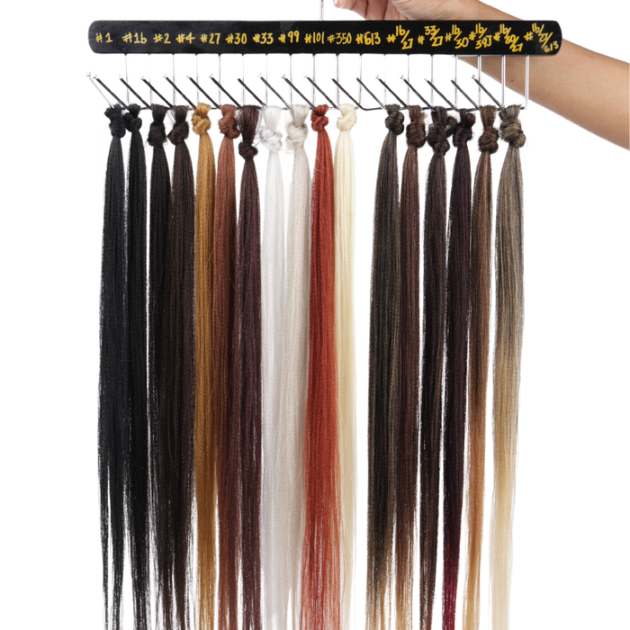 Collection of hair extensions in various colors on a display stand.