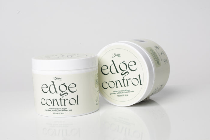 Two containers of organic 'edge control' hair product on a white background