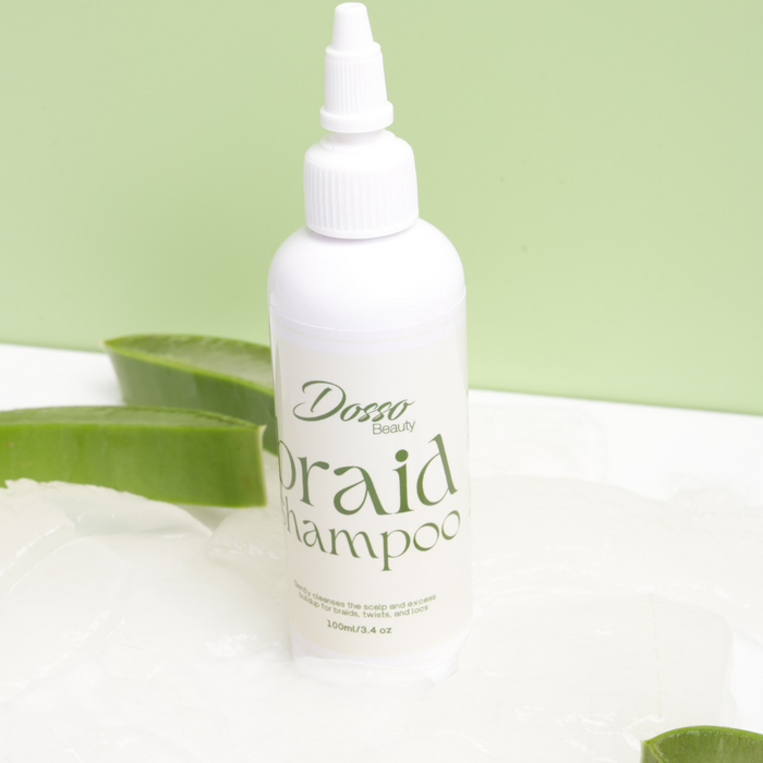 Dosso Beauty braid shampoo bottle with aloe vera leaves on a light green background