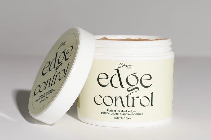 Dosso Beauty edge control jar with open lid, showcasing smooth styling gel designed for sleek edges and long-lasting hold.