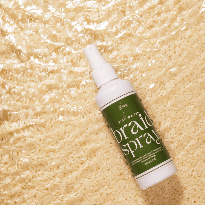 Dosso Beauty rice water braid spray bottle on rice background for hydration and hair strengthening